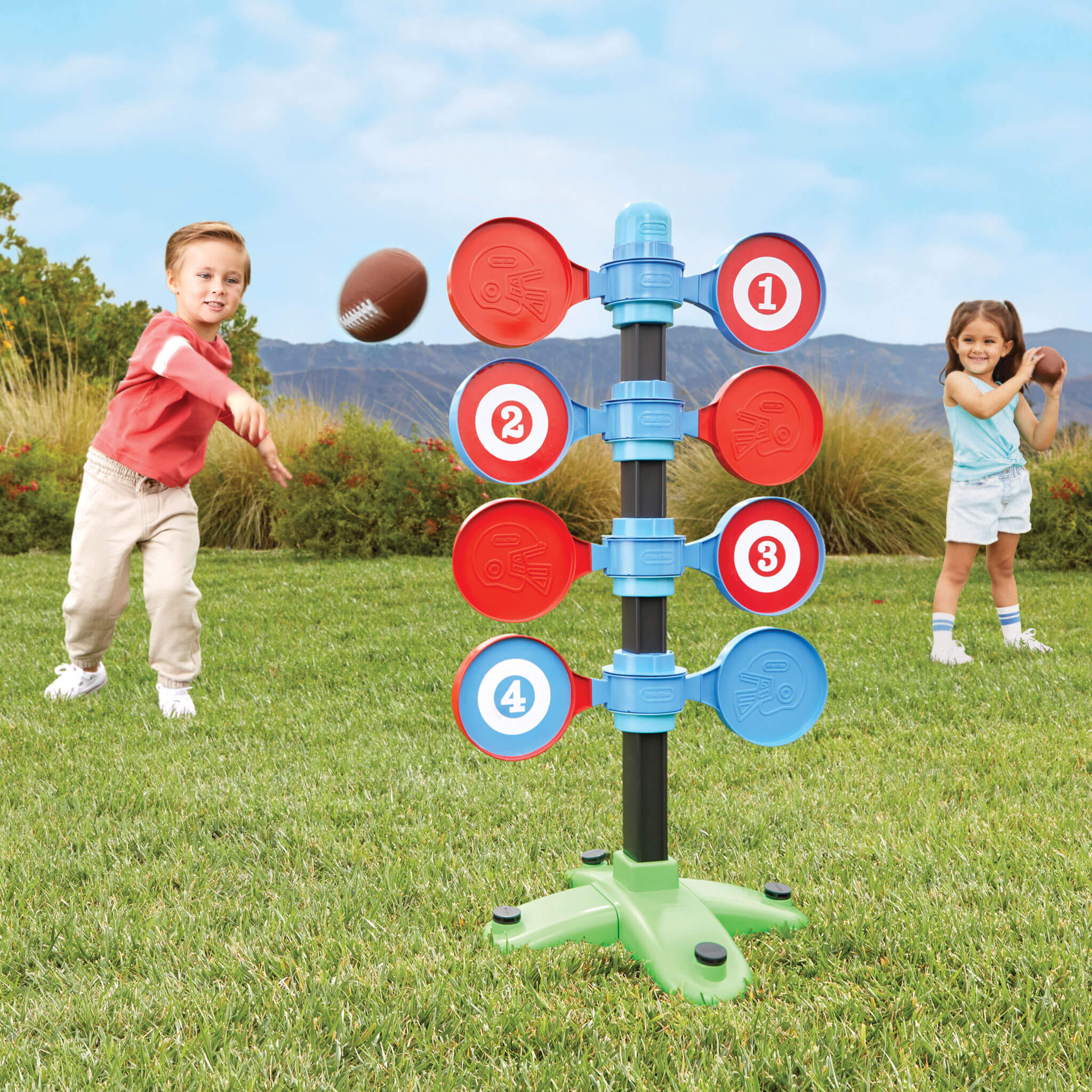 Girl and boy throwing footballs